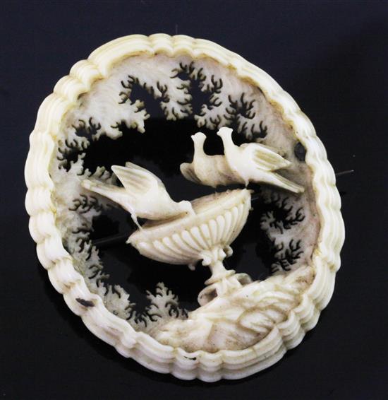 A late 19th/early 20th century ivory open work oval brooch, 1.75in.